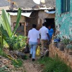 People delivering supplies to rural home.