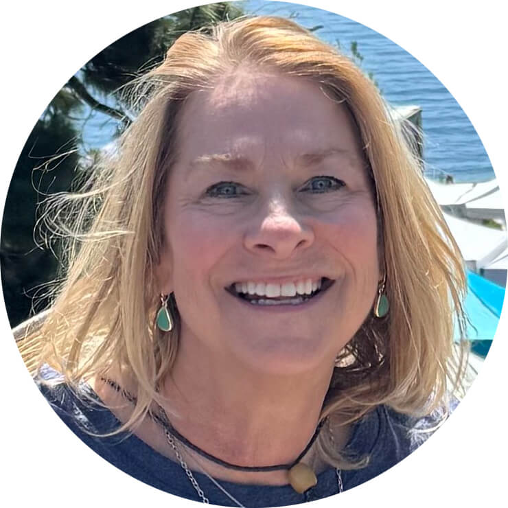 Smiling woman outdoors near water.