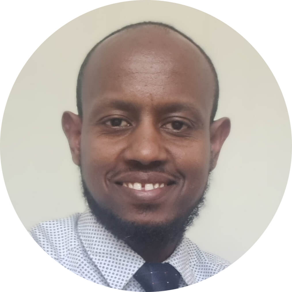 Smiling man with a beard and tie.