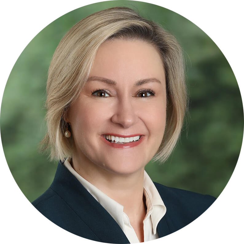 Smiling woman with short blonde hair.