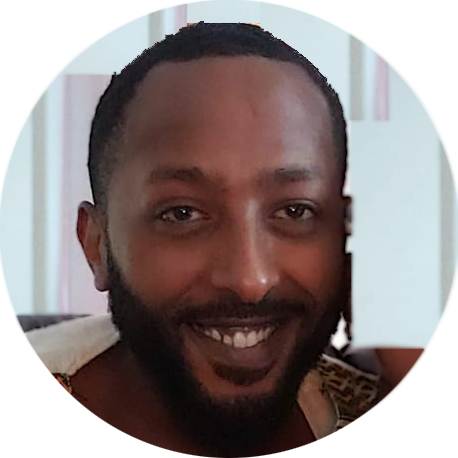 Smiling man with beard in circular frame.